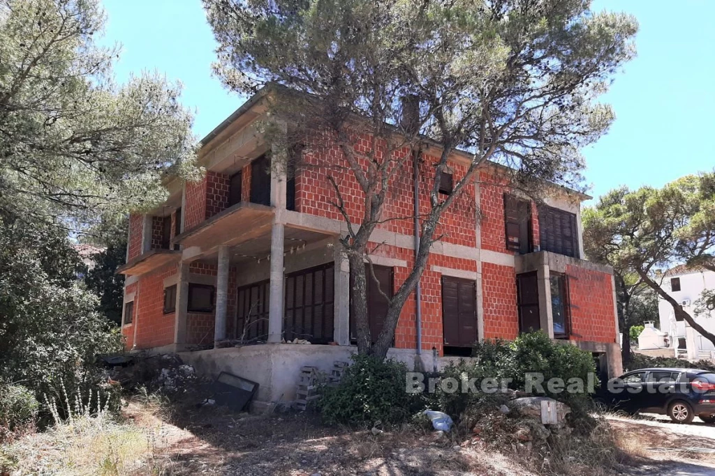 Unfinished apartment house in the first row from the sea