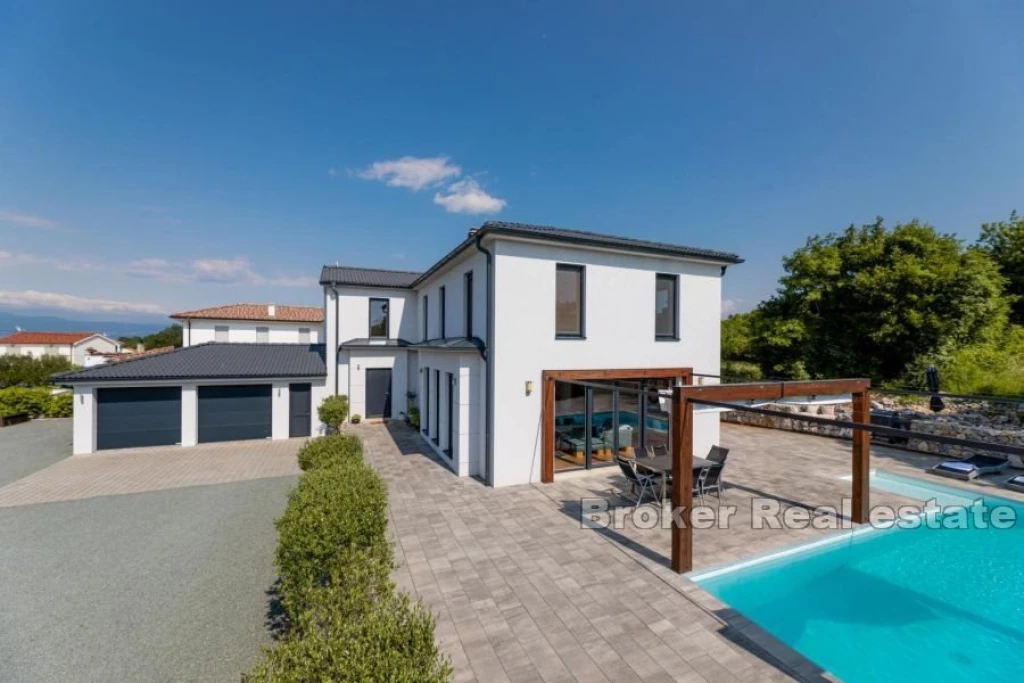 Modern house with a swimming pool on the edge of the green zone