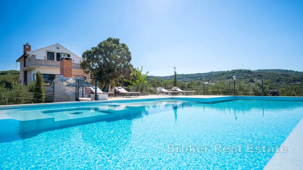 A beautiful house with a pool and a unique view