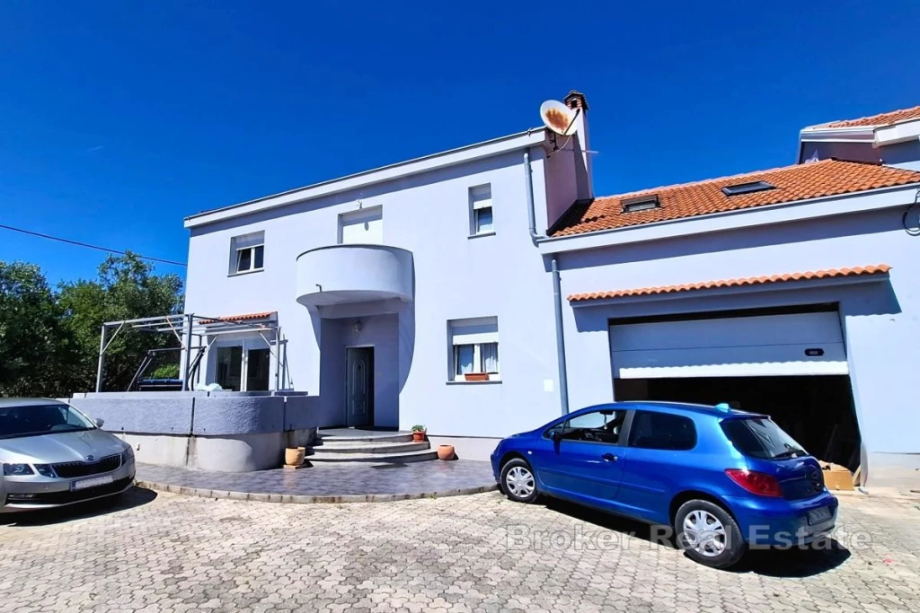 Spacious family house with a large yard and outbuildings