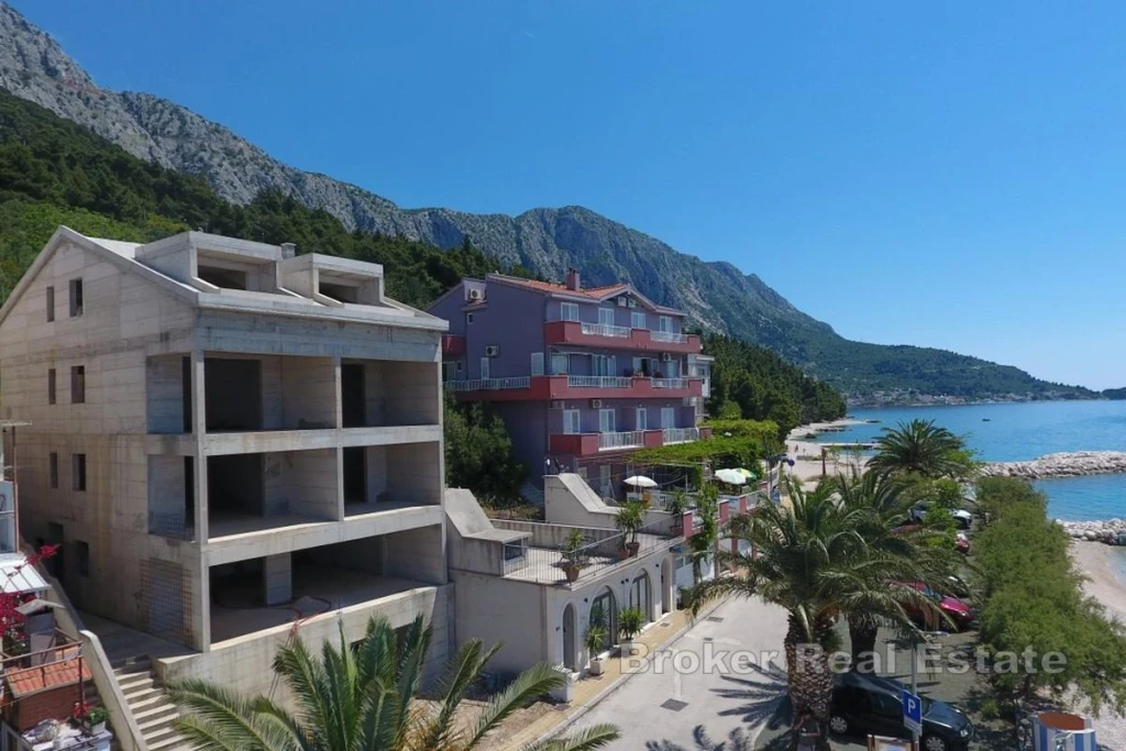 Unfinished apartment house in the first row to the sea