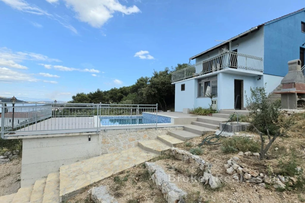 House with a pool and sea view