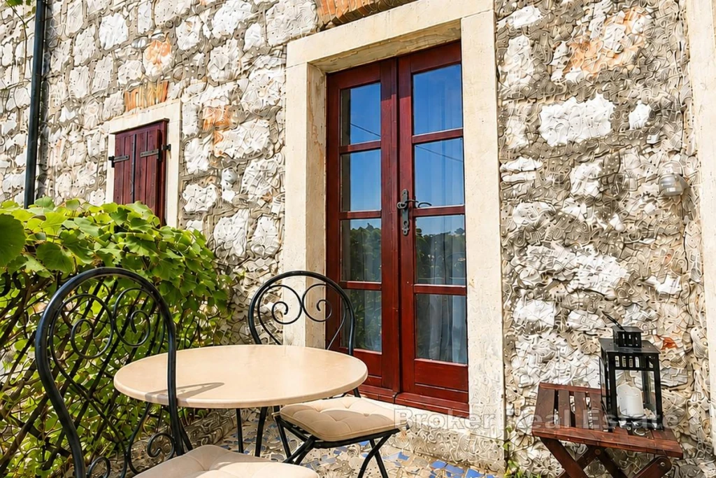Stone house with a courtyard and a balcony
